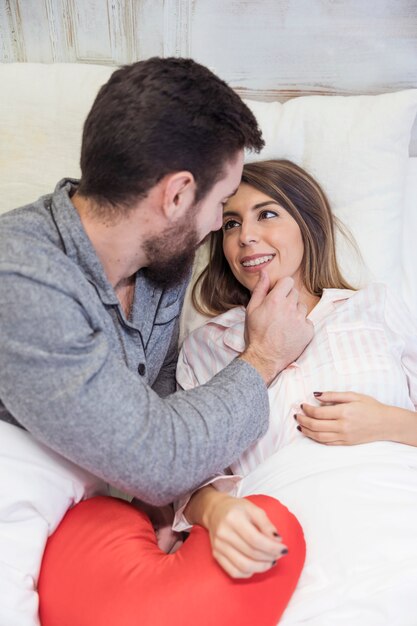 Free Photo Young Man Touching Face Of Woman In Bed