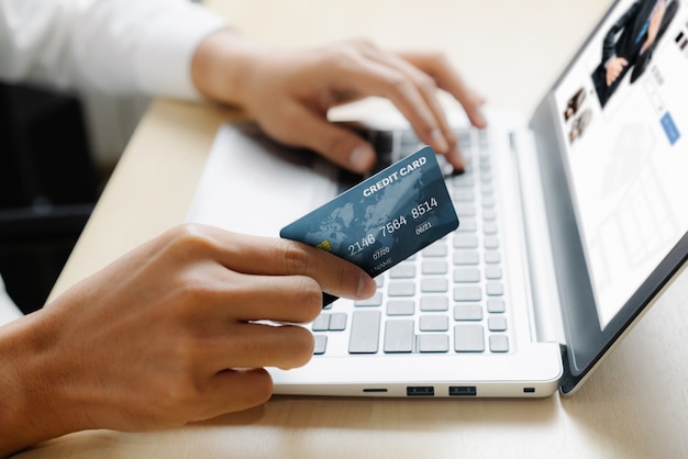 Premium Photo | Young man use credit card for online shopping