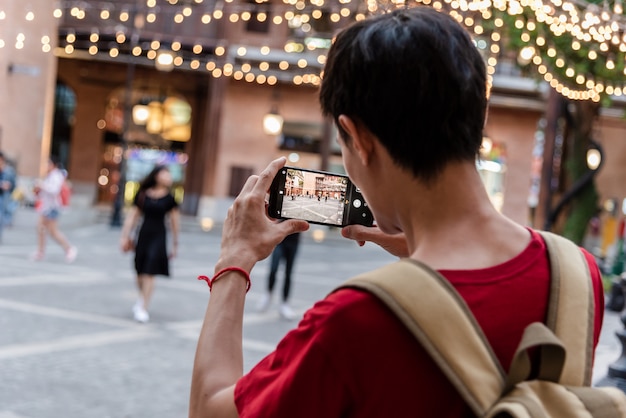 Young man using mobile smartphone take a picture by camera app. Premium Photo