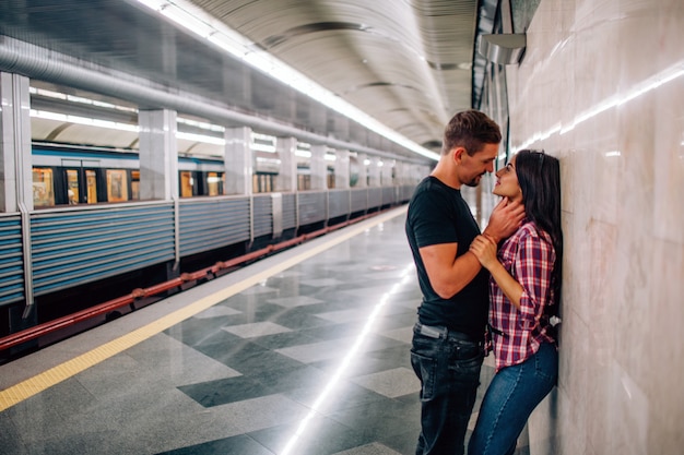 young-man-woman-use-underground-couple-subway-cheerful-paasionate-people-lean-wall-kissing-time-guy-hold-hand-her-neck-love-story-modern-urban-view_152404-9141.jpg