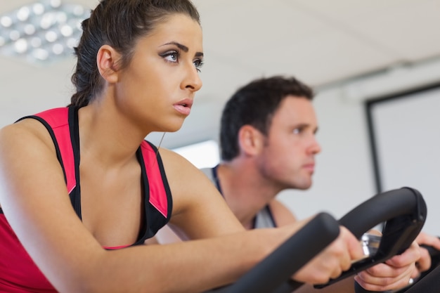 Premium Photo Young Man And Woman Working Out At Spinning Class