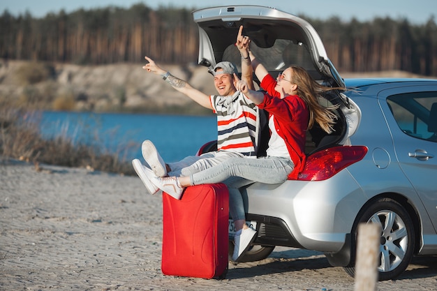 Premium Photo | Young married couple in vacation. journey on the car ...