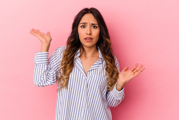 Premium Photo | Young mexican woman isolated on pink wall confused and ...