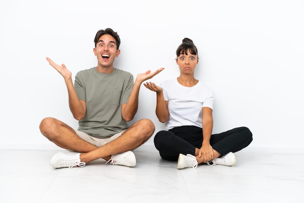 Premium Photo | Young mixed race couple sitting on the floor isolated ...