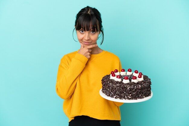 Premium Photo | Young mixed race woman holding birthday cake thinking