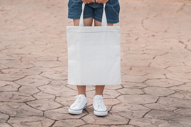 Download Young model holding white tote bag for mockup blank ...