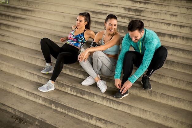 Young people resting on stairs after training Premium Photo