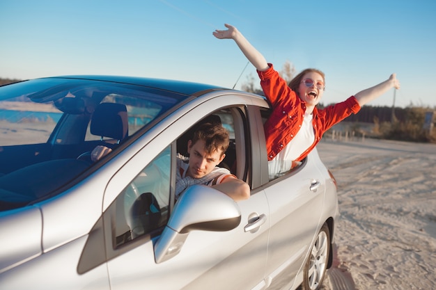 Premium Photo | Young people traveling by car. couple having an ...