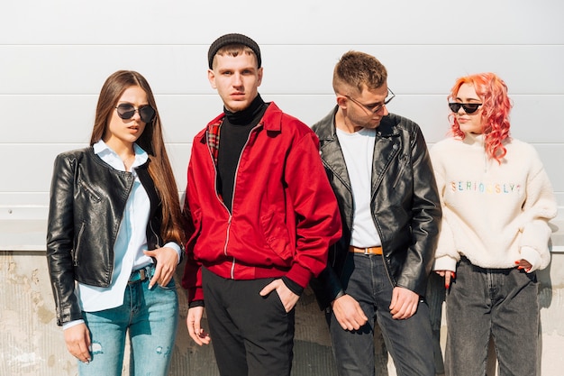 Young people in trendy wear posing on street Free Photo