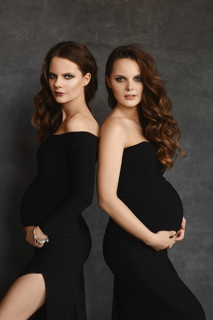 Premium Photo Young Pregnant Women In Black Dresses With Big Tummies