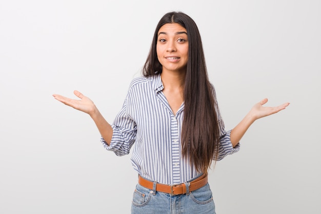 Premium Photo | Young pretty arab woman confused and doubtful shrugging ...