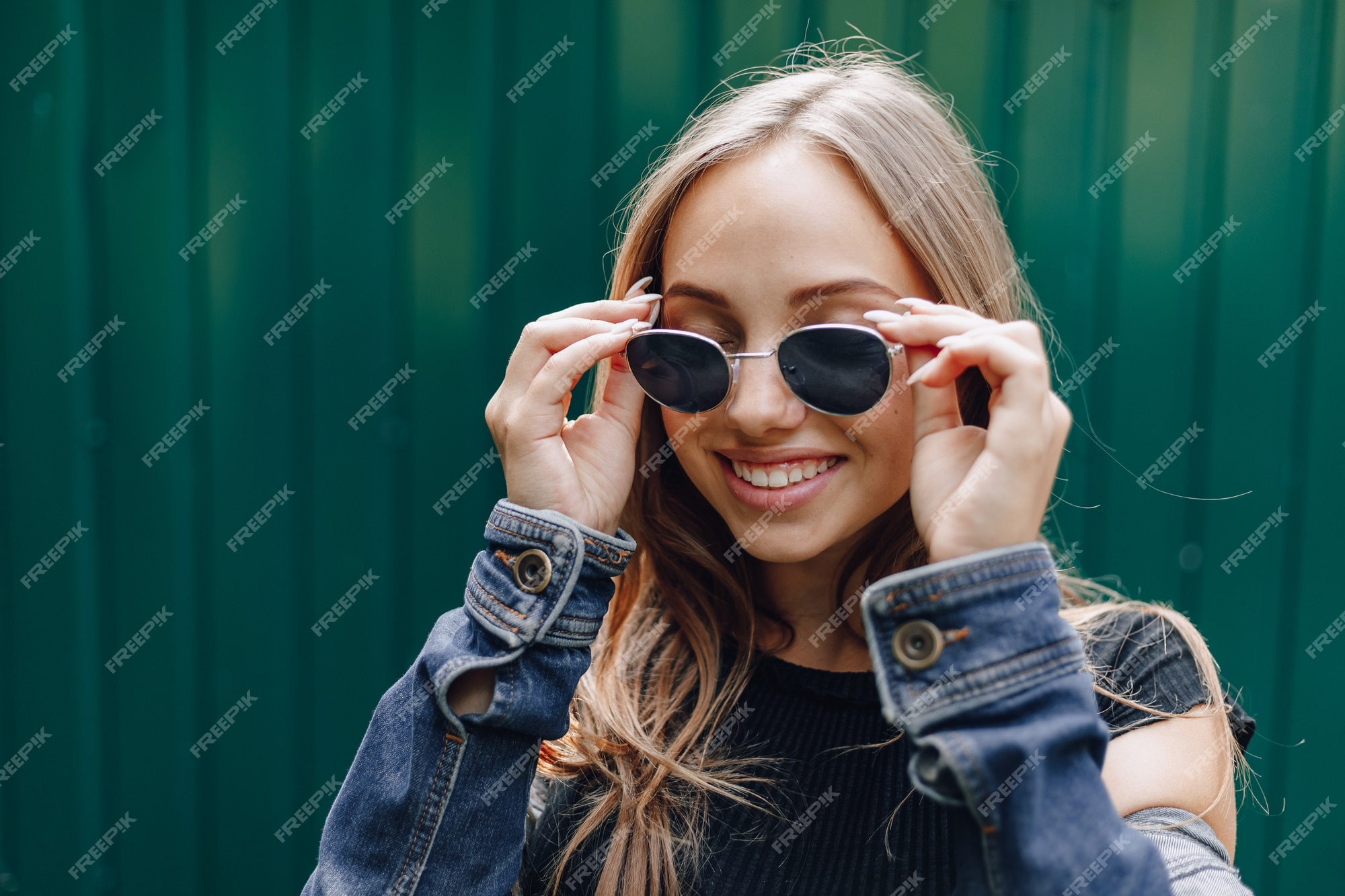 Free Photo Young Pretty Attractive Girl In Denim Clothes In Glasses On A Simple Dark Green 7665