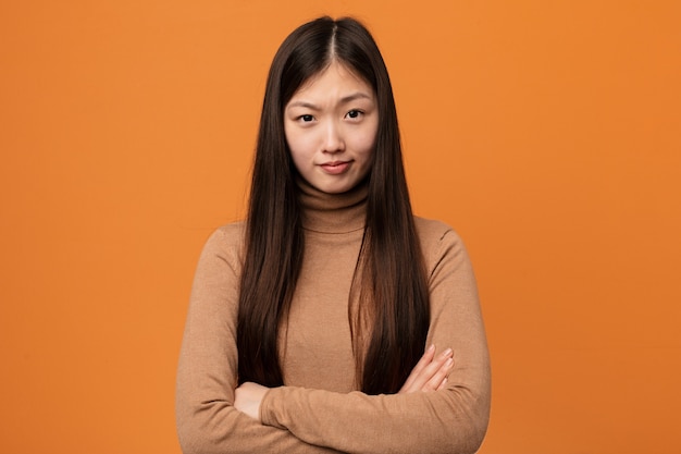 Premium Photo Young Pretty Chinese Woman Unhappy Looking In Camera With Sarcastic Expression