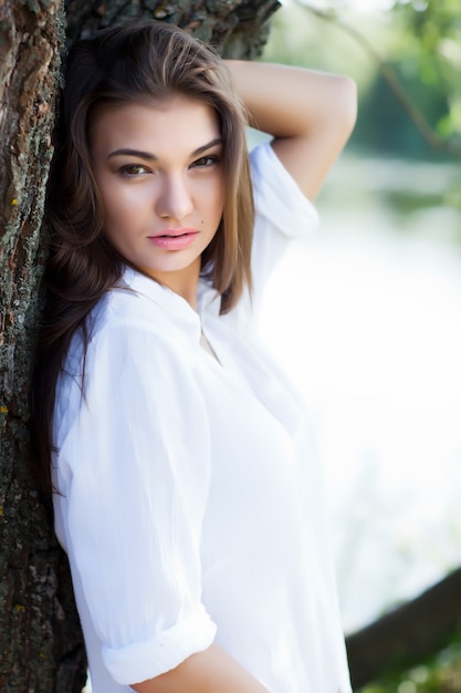 Premium Photo Young Sexy Brunette Woman In White Dress Sitting On