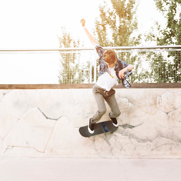 Free Photo | Young skater boy skating in half pipe