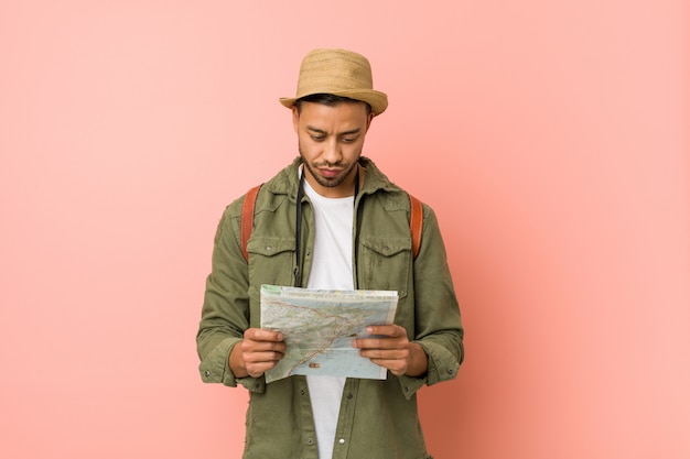 Young South Asian Man Holding A Map Photo Premium Download