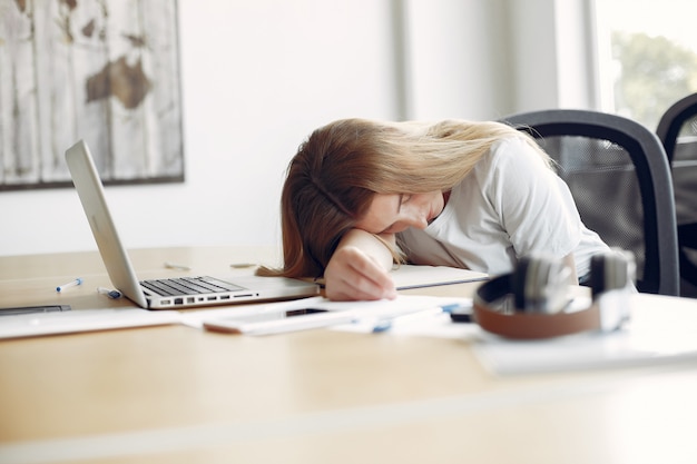 Young student sitting at the table and sleeping Free Photo