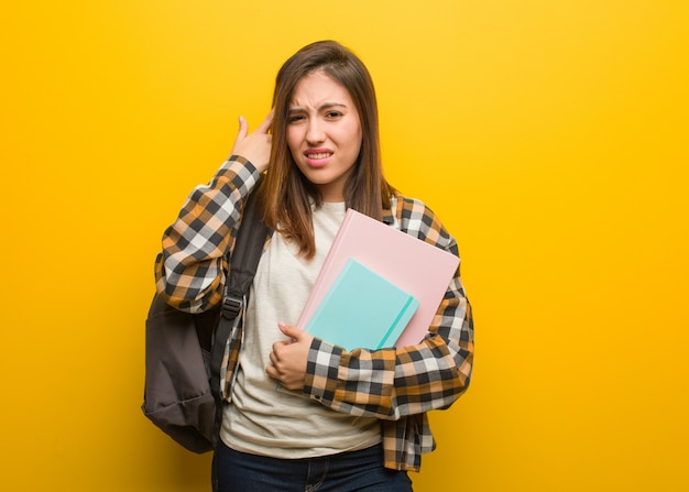 Young student woman doing a disappointment gesture with finger Premium Photo