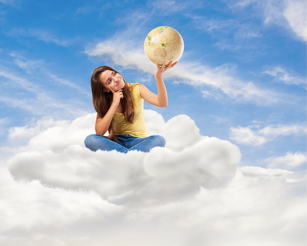 young student woman looking her world globe sitting on a cloud Free Photo