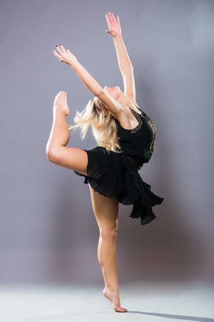 Free Photo | Young and stylish dancer posing on grey background