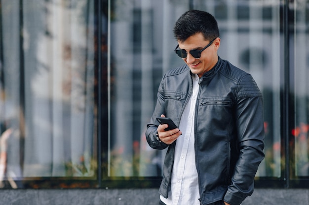 Premium Photo | Young stylish guy in glasses in black leather jacket ...