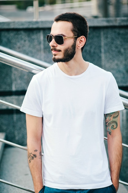 Premium Photo | A young stylish man with a beard in a white t-shirt and ...