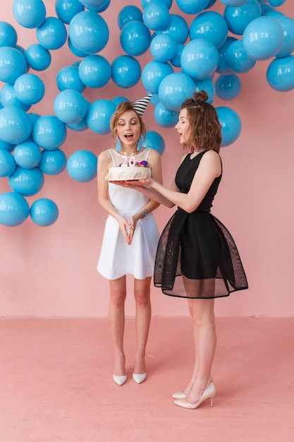 Free Photo | Young surprised girl holding a birthday cake and her ...