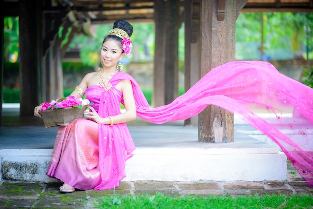 Young thai girl with traditional northern style dress in old temple, chiang mai, thailand Premium Photo