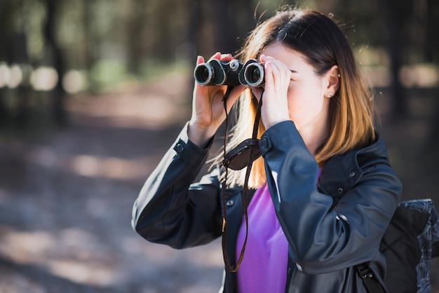 Free Photo | Young tourist using binoculars