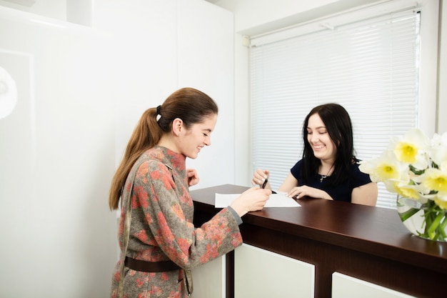 Premium Photo | Young woman administrator in a dental clinic in the