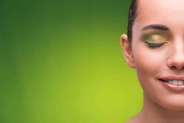 Young woman in beauty concept on green Premium Photo