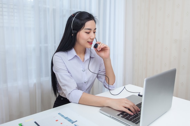 Young Woman Call Center Operator Working In Office Service Desk