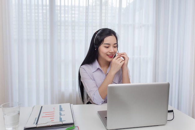 Young Woman Call Center Operator Working In Office Service Desk