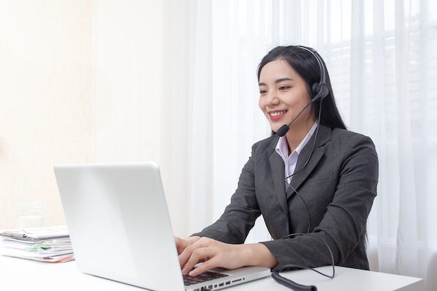 Young Woman Call Center Operator Working In Office Service Desk