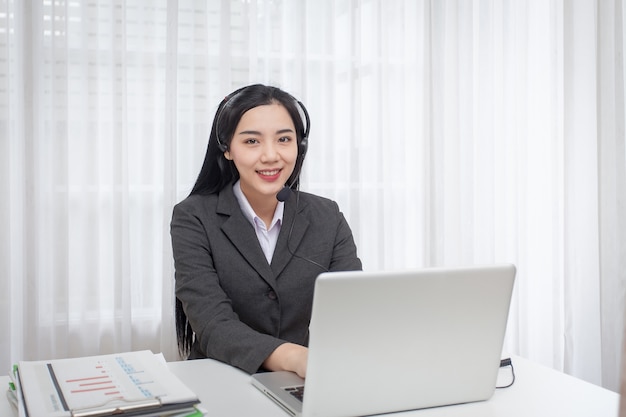 Young Woman Call Center Operator Working In Office Service Desk