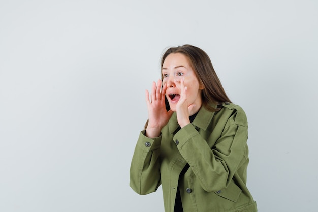 Free Photo | Young woman calling someone with loud voice in green ...