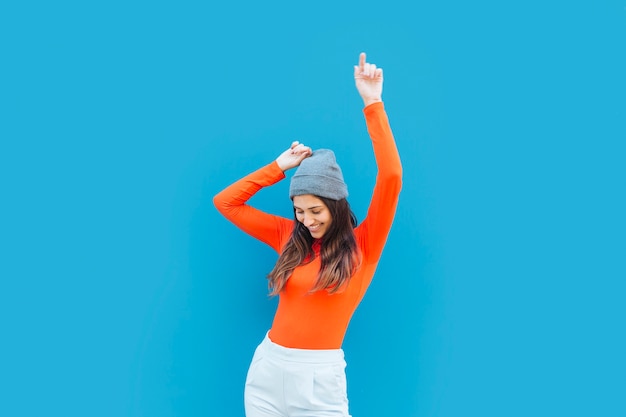 young-woman-dancing-with-arm-raised-front-blue-backdrop_23-2148204732.jpg (626×417)