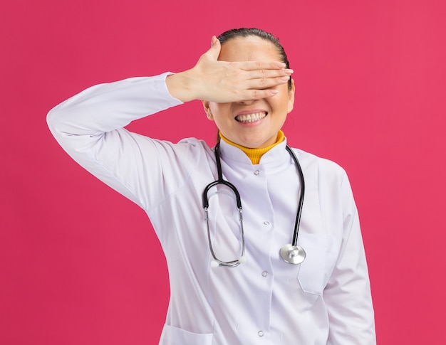 Free Photo | Young woman doctor covering eyes with hand smiling
