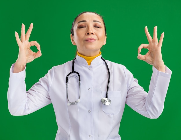 Free Photo | Young woman doctor relaxing with closed eyes making ...