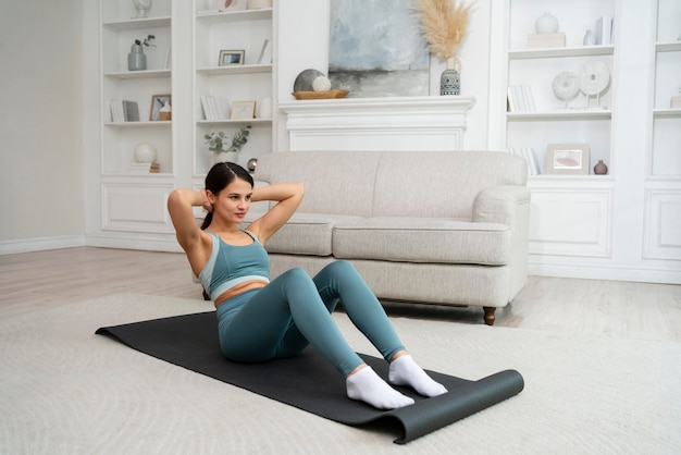 Premium Photo Young Woman Doing Her Workout On A Fitness Mat 