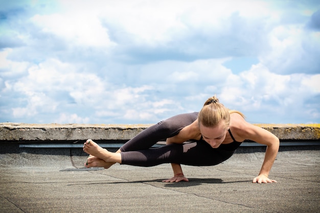 Premium Photo | Young woman doing yoga, ashtavakrasana