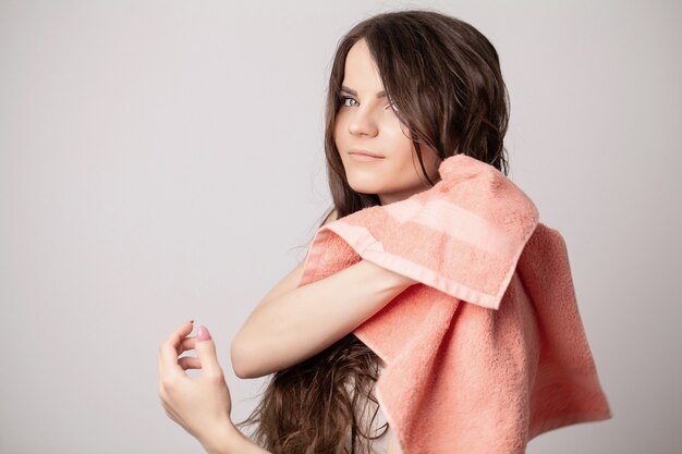 Premium Photo Young Woman Drying Her Hair With Towel On Light Background