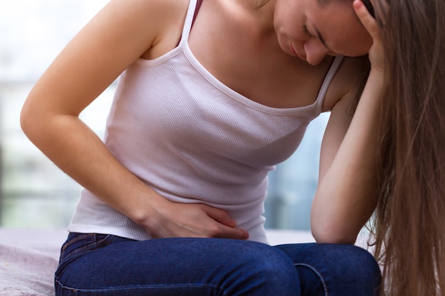 premium-photo-young-woman-feels-abdominal-pain-during-the-period