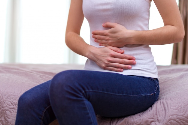 premium-photo-young-woman-feels-abdominal-pain-during-the-period-menstruation