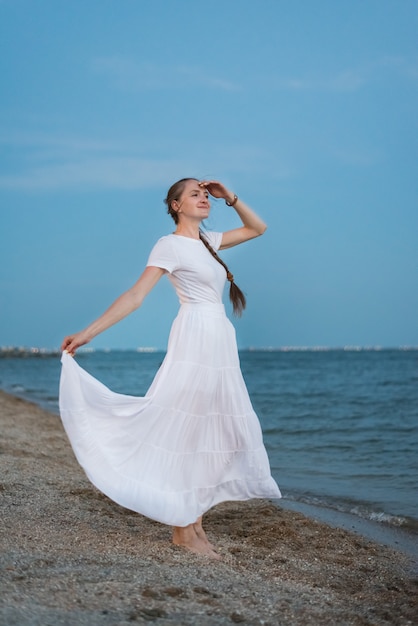 white dress by the shore