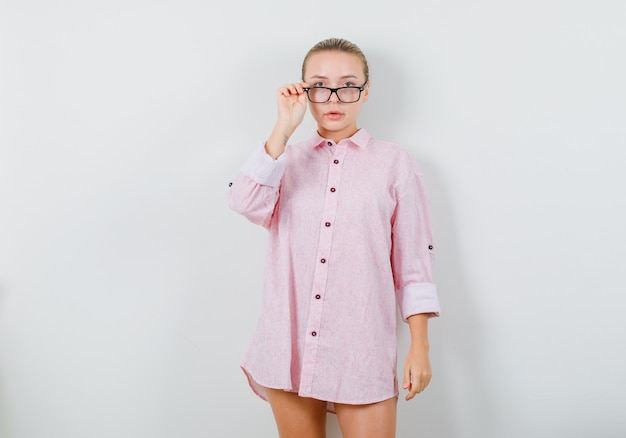 Free Photo Young Woman Looking Over Glasses In Pink Shirt And Looking Careful 1955