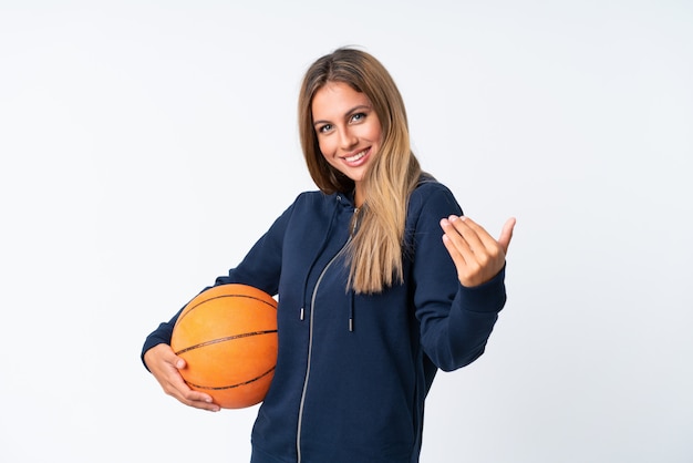 Young woman playing basketball over isolated white Premium Photo