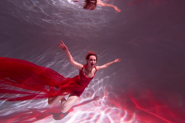 Free Photo | Young woman posing submerged underwater in a flowy dress