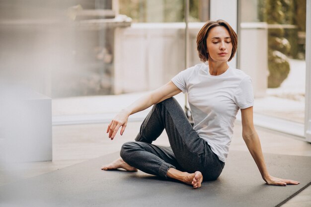 Young woman practicing yoga at home Free Photo
