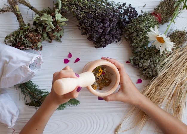 Premium Photo | A Young Woman Preparing Ayurvedic Medicine In The ...